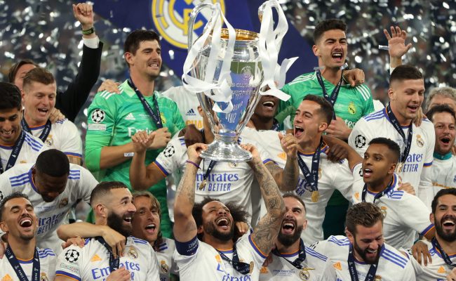 Soccer Football - Champions League Final - Liverpool v Real Madrid - Stade de France, Saint-Denis near Paris, France - May 28, 2022 Real Madrid's Marcelo celebrates winning the champions league with the trophy and teammates REUTERS/Molly Darlington